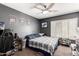 Bedroom with a large bed, ceiling fan, and car posters at 2415 W Desperado Way, Phoenix, AZ 85085