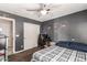 Bedroom with a large bed, ceiling fan, and car posters at 2415 W Desperado Way, Phoenix, AZ 85085