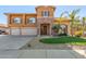 Two-story house with three-car garage and landscaped front yard at 2415 W Desperado Way, Phoenix, AZ 85085