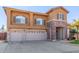 Two-story house with three-car garage and front yard at 2415 W Desperado Way, Phoenix, AZ 85085