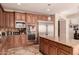 Modern kitchen with double oven, large refrigerator, and granite island at 2415 W Desperado Way, Phoenix, AZ 85085