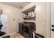 Bright laundry room with washer, dryer, and extra storage at 2415 W Desperado Way, Phoenix, AZ 85085