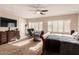 Main bedroom with large TV and sitting area at 2415 W Desperado Way, Phoenix, AZ 85085