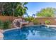 Inviting swimming pool with a rock waterfall feature at 2415 W Desperado Way, Phoenix, AZ 85085