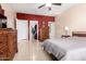 Bedroom with gray bedding, red accent wall, and walk-in closet at 28452 N Crimm Rd, San Tan Valley, AZ 85143