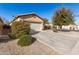 Tan house with a two-car garage and driveway, side yard view at 28452 N Crimm Rd, San Tan Valley, AZ 85143