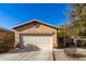 Tan one-story house with a two-car garage and small front yard at 28452 N Crimm Rd, San Tan Valley, AZ 85143
