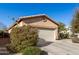 Tan house with a two-car garage, side yard view with desert landscaping at 28452 N Crimm Rd, San Tan Valley, AZ 85143