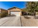 One-story house with tan exterior, two-car garage, and desert landscaping at 28452 N Crimm Rd, San Tan Valley, AZ 85143