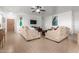 Living room with tile floors, neutral colored couches and a ceiling fan at 28452 N Crimm Rd, San Tan Valley, AZ 85143