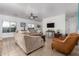 Spacious living room with tile floors, neutral furniture, and ceiling fan at 28452 N Crimm Rd, San Tan Valley, AZ 85143