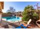 Inviting kidney-shaped pool with patio seating at 28452 N Crimm Rd, San Tan Valley, AZ 85143