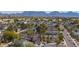 Neighborhood shot showcasing various home styles, mature trees, and picturesque mountain views in the background at 3024 E Siesta Ln, Phoenix, AZ 85050