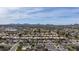 Wide aerial shot of a suburban neighborhood with houses, palm trees, and distant mountain views at 3024 E Siesta Ln, Phoenix, AZ 85050