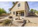 Lovely backyard with a water fountain, fire pit, desert landscaping, and covered patio area at 3024 E Siesta Ln, Phoenix, AZ 85050