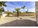 Backyard features desert landscaping with palm trees and an extended patio area at 3024 E Siesta Ln, Phoenix, AZ 85050