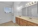 Bright bathroom offers dual sinks, wood cabinetry, and well-lit vanity mirrors at 3024 E Siesta Ln, Phoenix, AZ 85050