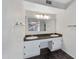 Double vanity bathroom with dark countertops and a large mirror at 3024 E Siesta Ln, Phoenix, AZ 85050