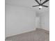 Bright bedroom boasts neutral carpet, ceiling fan, and convenient closet access at 3024 E Siesta Ln, Phoenix, AZ 85050
