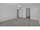 Neutral bedroom features carpet, ceiling fan, and entryways to bathroom and closet at 3024 E Siesta Ln, Phoenix, AZ 85050