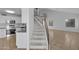 Bright entryway with staircase, tiled floors, and access to living areas and the kitchen at 3024 E Siesta Ln, Phoenix, AZ 85050
