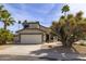 Inviting single-Gathering home with a two-car garage and desert landscaping featuring mature palm trees at 3024 E Siesta Ln, Phoenix, AZ 85050