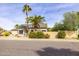 Charming single-story home featuring desert landscaping, palm trees, and neutral-colored exterior at 3024 E Siesta Ln, Phoenix, AZ 85050