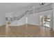 Spacious living room with open staircase, high ceilings, neutral walls and light-filled windows at 3024 E Siesta Ln, Phoenix, AZ 85050