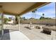 Relaxing covered patio featuring palm trees, a decorative fountain, and a fire pit at 3024 E Siesta Ln, Phoenix, AZ 85050