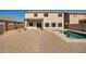 Home's backyard with pool and patio cover at 30313 W Mitchell Ave, Buckeye, AZ 85396