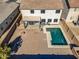 An aerial view of a backyard with a pool, patio, and fire pit at 30313 W Mitchell Ave, Buckeye, AZ 85396