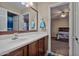 Bathroom with a vanity and view into bedroom at 30313 W Mitchell Ave, Buckeye, AZ 85396