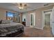 Primary bedroom with a queen bed, TV, and access to bathroom at 30313 W Mitchell Ave, Buckeye, AZ 85396