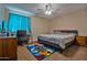Bedroom with a bed, desk, and ceiling fan at 30313 W Mitchell Ave, Buckeye, AZ 85396