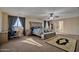 Main bedroom with ensuite bathroom and large windows at 30313 W Mitchell Ave, Buckeye, AZ 85396