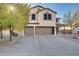 Two-story house with a two-car garage and mature trees at 30313 W Mitchell Ave, Buckeye, AZ 85396