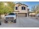 Two-story house with a two-car garage, landscaping, and a truck parked in the driveway at 30313 W Mitchell Ave, Buckeye, AZ 85396