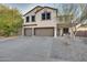 Two-story house with a three-car garage and desert landscaping at 30313 W Mitchell Ave, Buckeye, AZ 85396