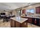 Island kitchen with granite countertops and wood cabinets at 30313 W Mitchell Ave, Buckeye, AZ 85396