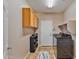 Laundry room with washer, dryer, cabinets, and shoe storage at 30313 W Mitchell Ave, Buckeye, AZ 85396