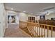Spacious loft area with wood railing and carpet at 30313 W Mitchell Ave, Buckeye, AZ 85396