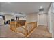 Loft overlooking main living area, with wood railing and carpet at 30313 W Mitchell Ave, Buckeye, AZ 85396