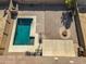 An aerial view of a backyard with a sparkling pool, patio, and fire pit at 30313 W Mitchell Ave, Buckeye, AZ 85396