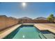 Sparkling clean rectangular pool in backyard at 30313 W Mitchell Ave, Buckeye, AZ 85396