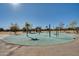 Circular spray park with colorful water features for children at 30313 W Mitchell Ave, Buckeye, AZ 85396