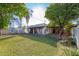 Large backyard with grassy area and home view at 3126 E Monte Vista Rd, Phoenix, AZ 85008