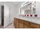 Bathroom featuring wood vanity, red tile, and a large mirror at 3126 E Monte Vista Rd, Phoenix, AZ 85008