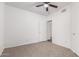 Bedroom with ceiling fan and carpet flooring, offering access to another room at 3126 E Monte Vista Rd, Phoenix, AZ 85008