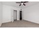 Bright bedroom with ceiling fan, carpet flooring, and double door closet at 3126 E Monte Vista Rd, Phoenix, AZ 85008