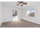 Well-lit bedroom featuring two windows, ceiling fan, and carpeted floor at 3126 E Monte Vista Rd, Phoenix, AZ 85008